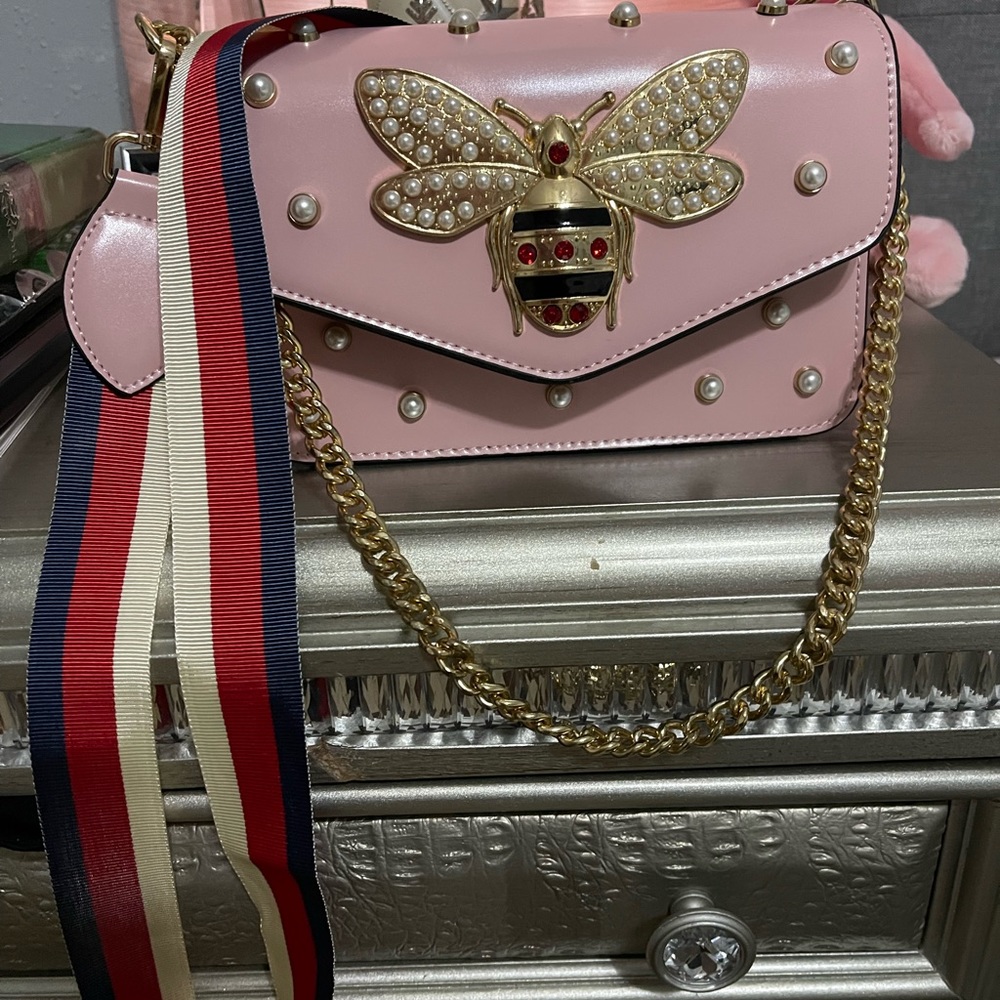 Pink shoulder bag with bee accents